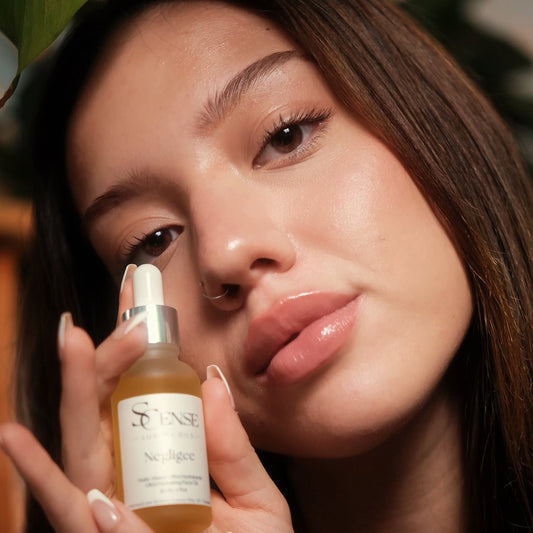Woman holding a skincare bottle with a blurred background
